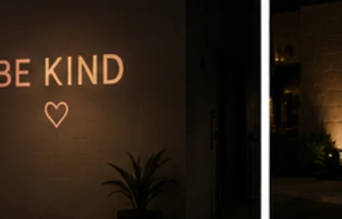 Be Kind projected on the wall in light