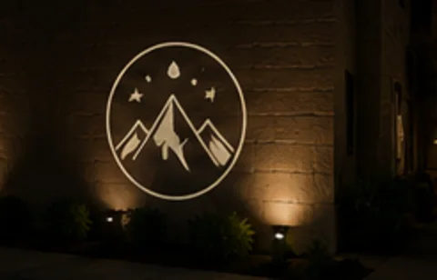 Summit Badge projected on the wall in light