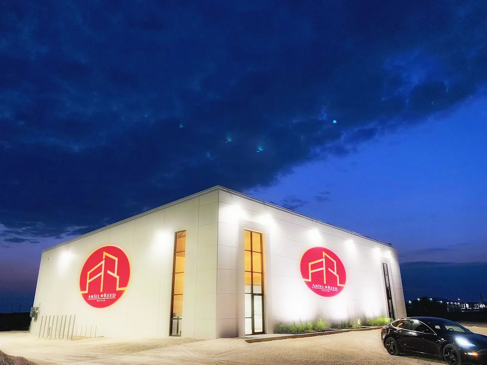 A real client logo, cast crisp across the whole building