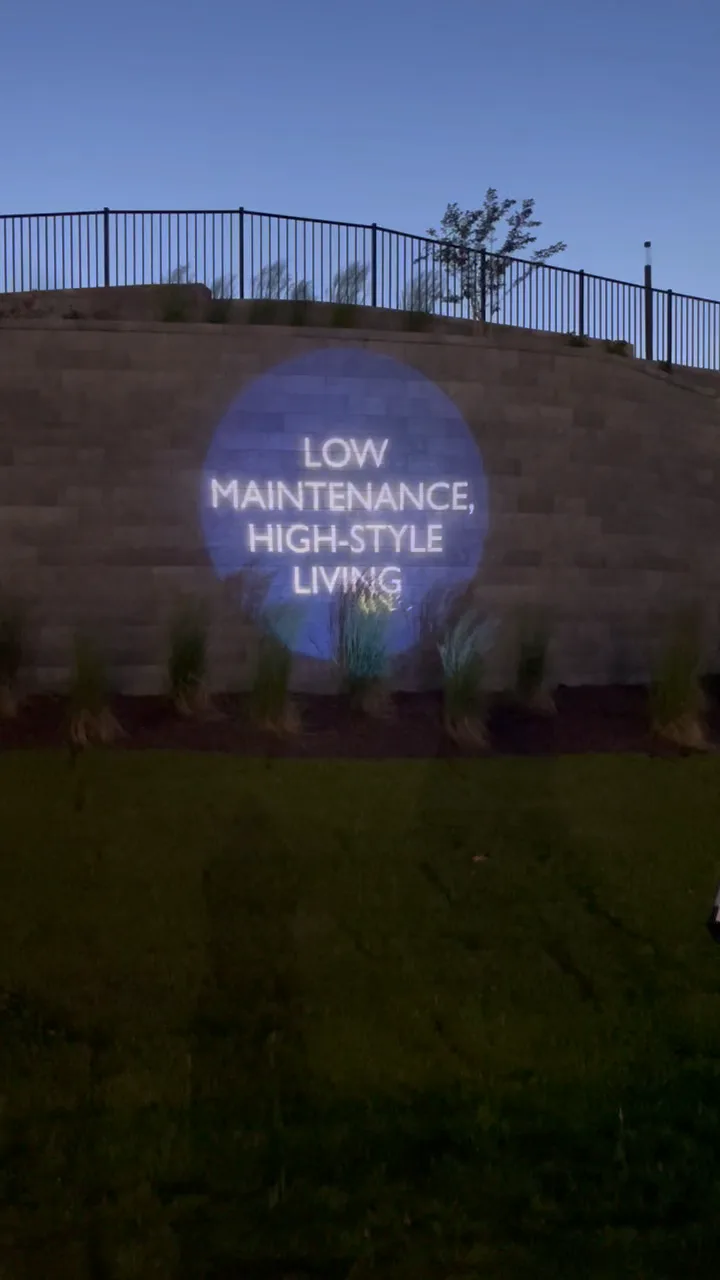 Low-maintenance community branding projected at an HHHunt Aire amenity area