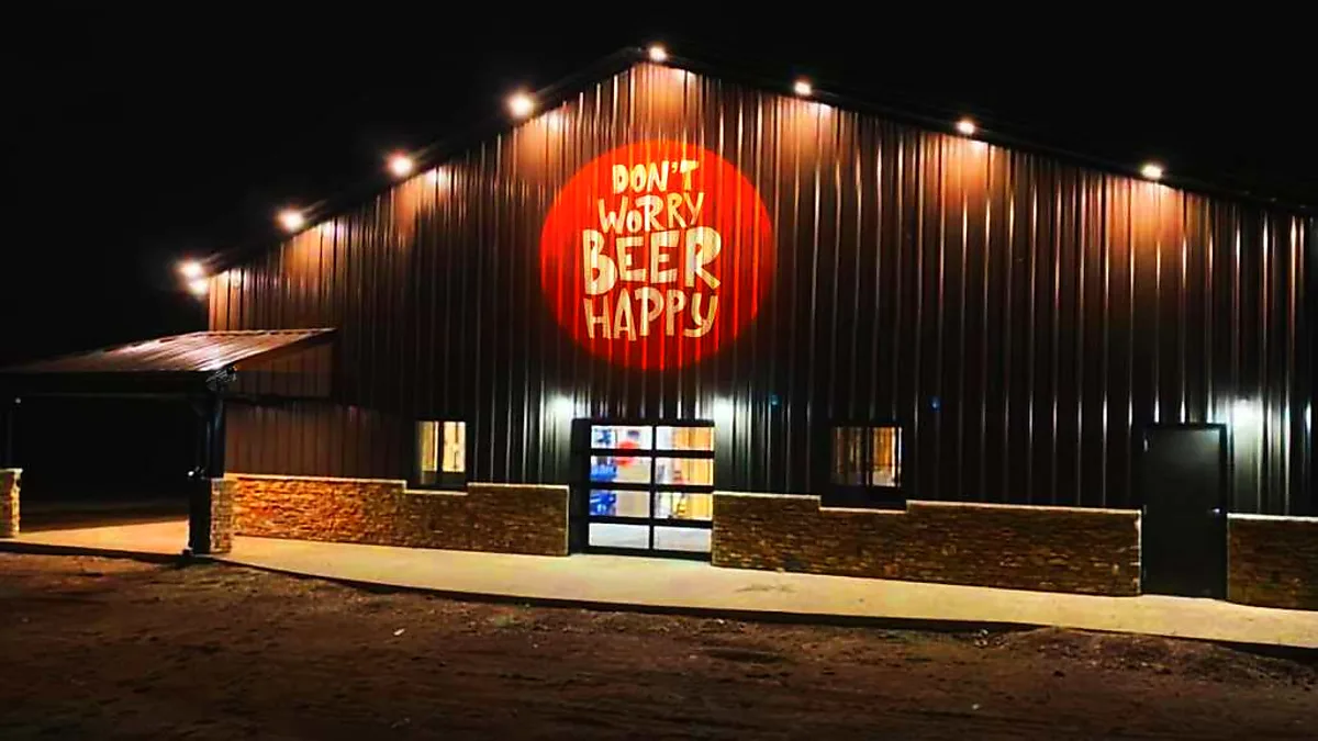 Outdoor logo projected on a brewery facade at night