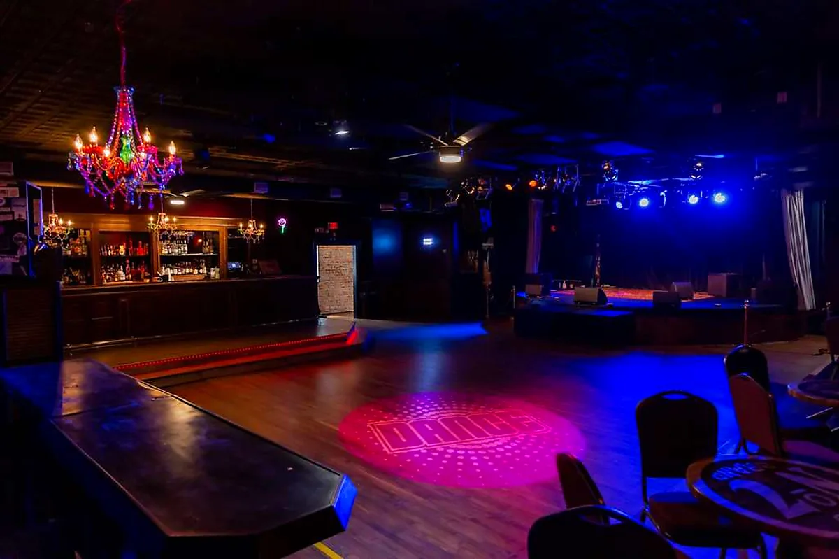 "DANCE" gobo projected onto an empty music-venue dance floor, ready for the night
