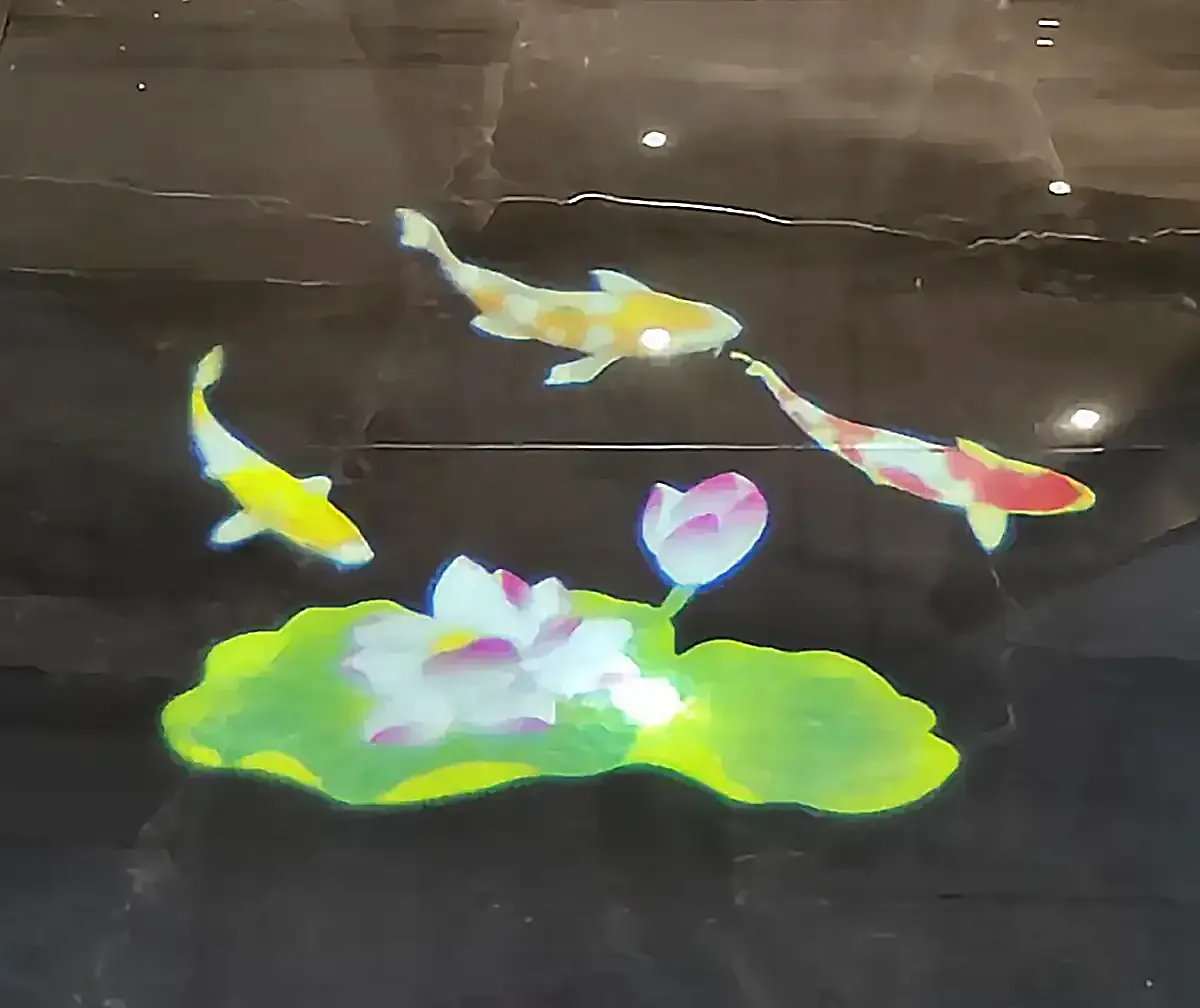 Full-color koi and lotus projection on a polished marble floor