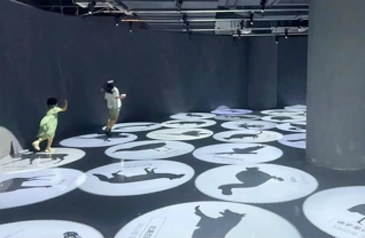 Kids playing a motion-activated floor game at a museum