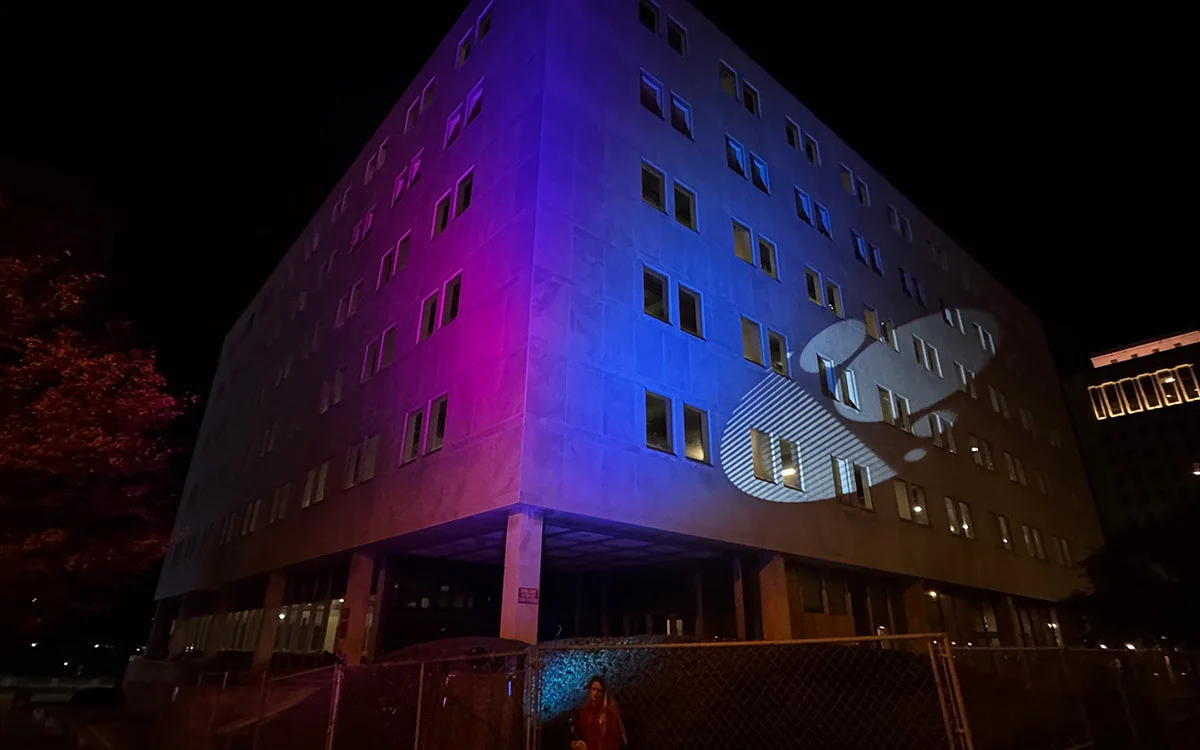 Buildings — Branded color wash and gobo mark across a building facade at night