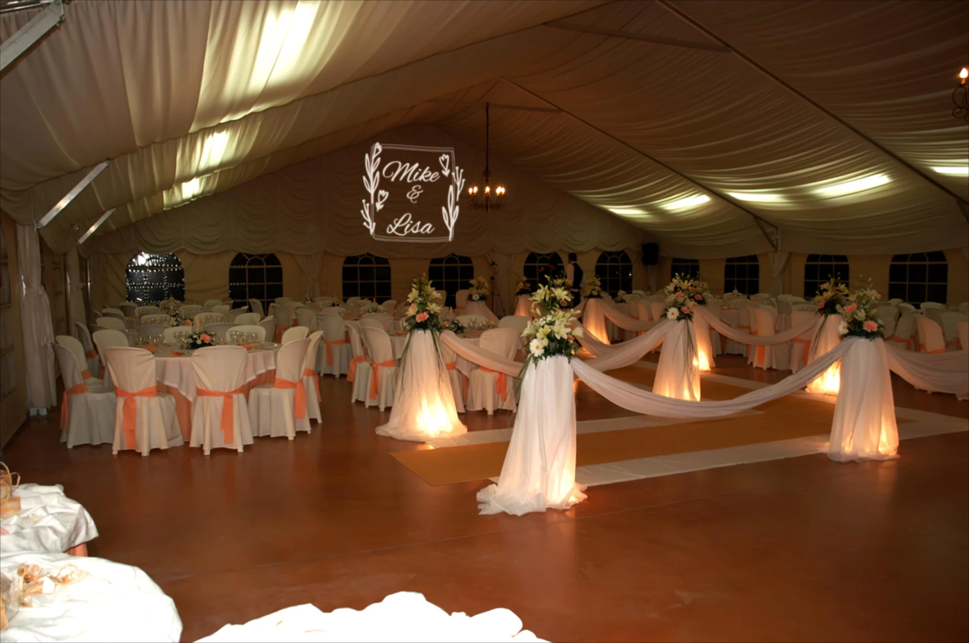 Mike & Lola wedding monogram projected inside an elegant white reception tent