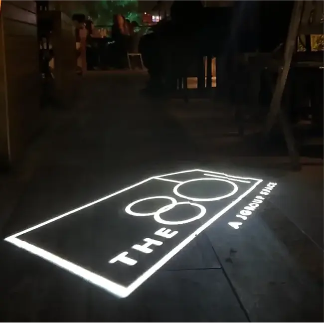 "THE 8" venue's real gobo projected on the walkway outside their venue at night