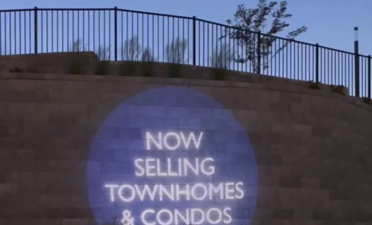 Real-estate "now selling" wall message — Infinity gobo logo projection
