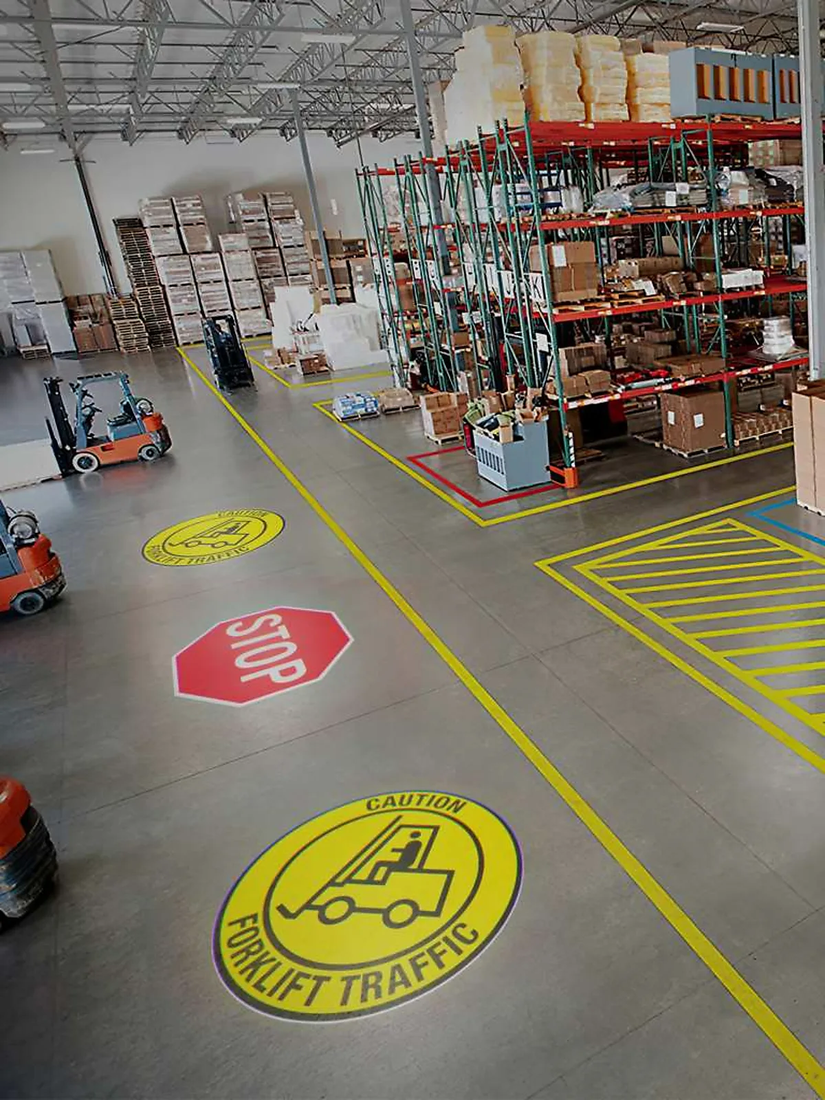 Stop and forklift safety signs projected on a busy warehouse concrete floor