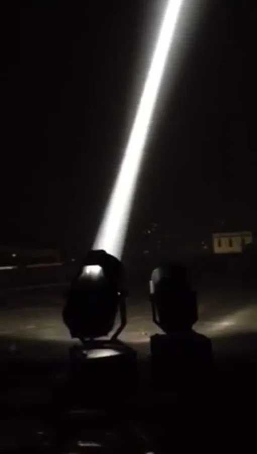 Real sky-beam searchlight throwing a bright white column of light into the night sky