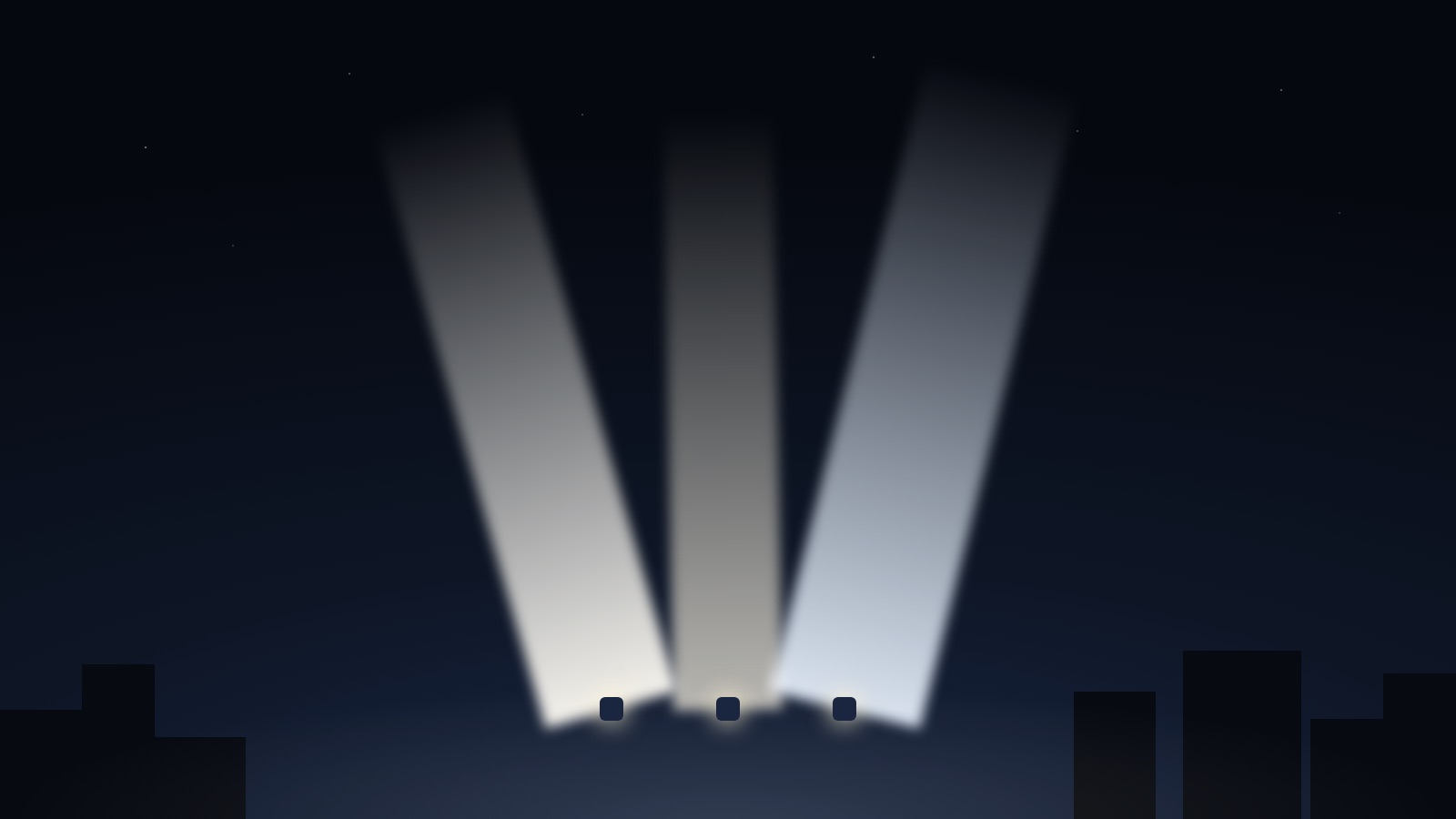 Three sky-beam searchlight beams crossing over a city skyline at night