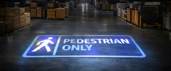Pedestrian-only walkway projected on a warehouse aisle floor